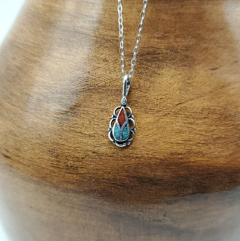 Small Teardrop pendant with multi-color stones. Crescent edge